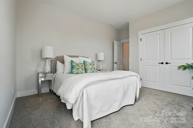bedroom with baseboards, carpet, and a closet