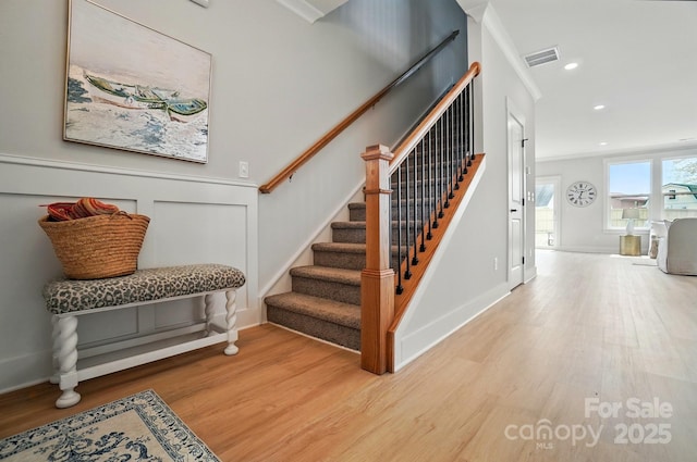 stairs featuring recessed lighting, baseboards, visible vents, and wood finished floors