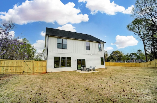 back of property with board and batten siding, a patio, a gate, and a fenced backyard