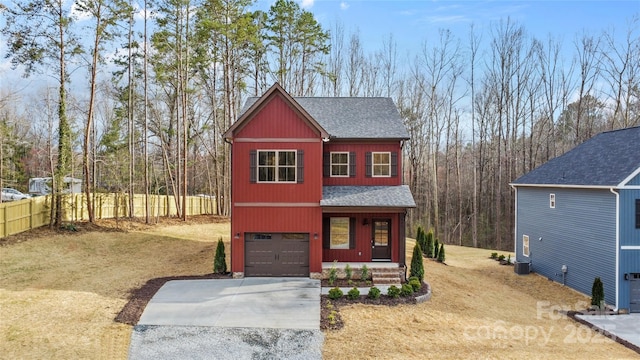 exterior space featuring a shingled roof, concrete driveway, fence, and a garage