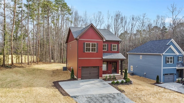 view of front of home featuring concrete driveway, a shingled roof, a front lawn, and an attached garage