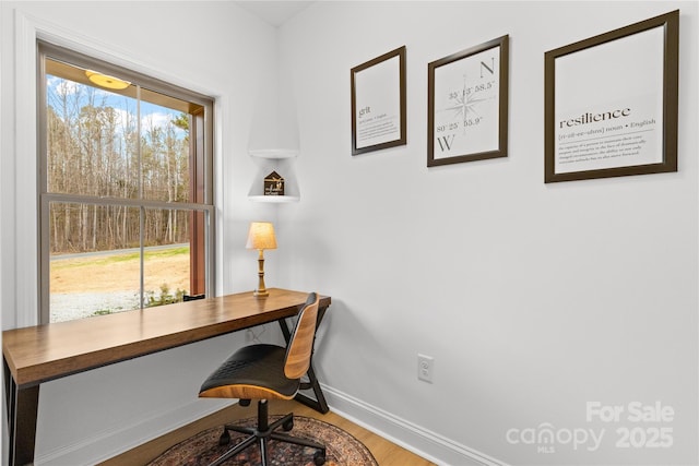 office area with baseboards and wood finished floors