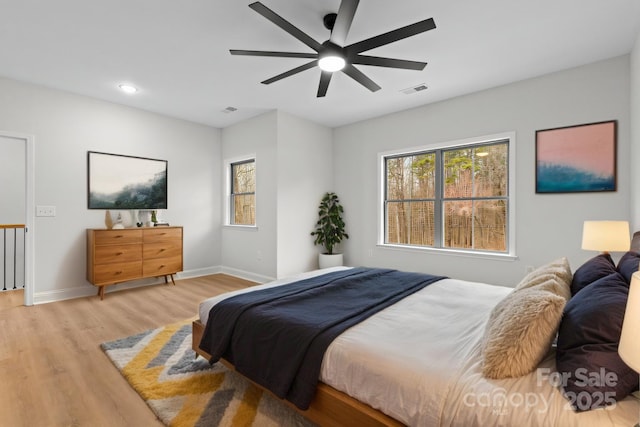 bedroom with visible vents, baseboards, light wood-style flooring, ceiling fan, and recessed lighting