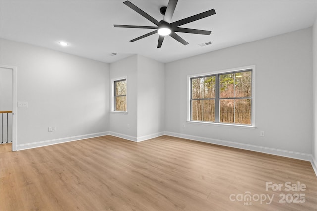 unfurnished room with light wood-type flooring, visible vents, baseboards, and recessed lighting