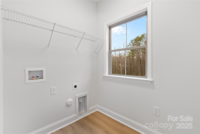 laundry room with hookup for a washing machine, hookup for an electric dryer, hookup for a gas dryer, laundry area, and baseboards