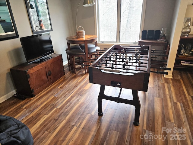 rec room with wood finished floors and baseboards