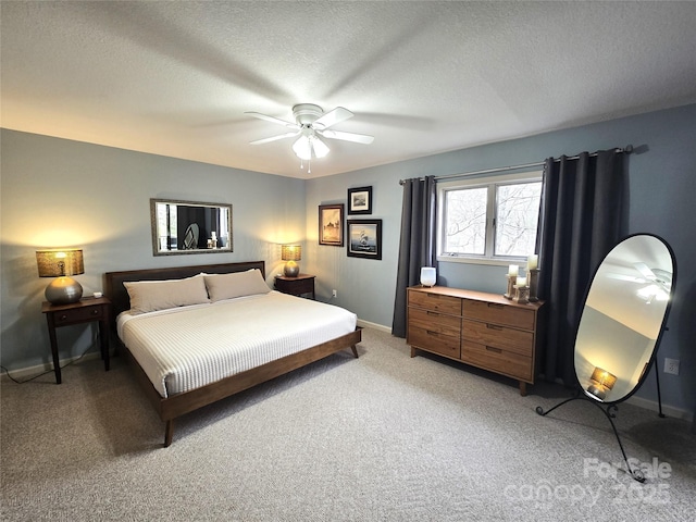 bedroom featuring light carpet, a ceiling fan, baseboards, and a textured ceiling