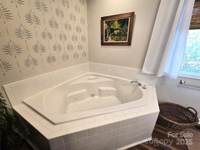 full bathroom with a tub with jets and wallpapered walls