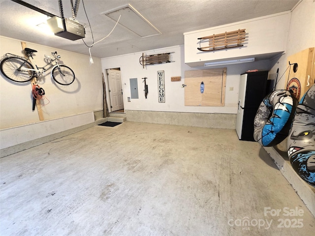 garage with electric panel and a garage door opener