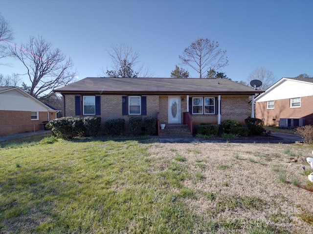 ranch-style house with a front yard, brick siding, and central AC