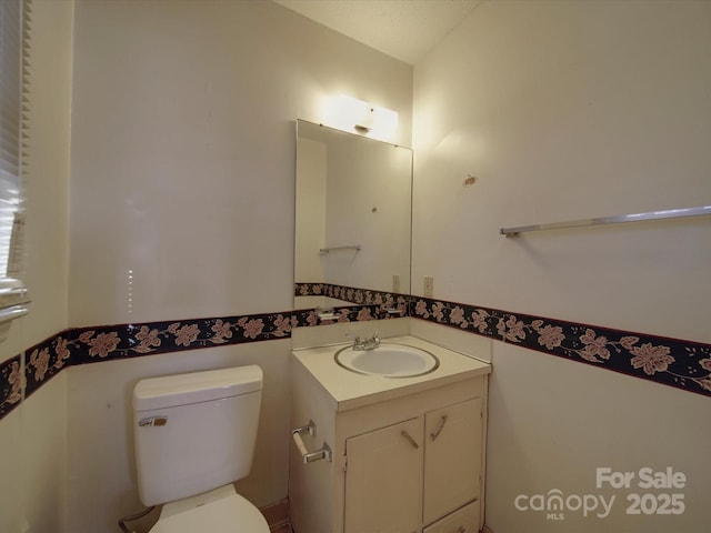 half bath with vanity and toilet