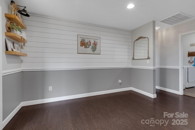 unfurnished dining area featuring baseboards, visible vents, and wood finished floors