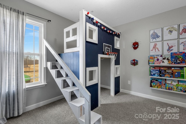 carpeted bedroom featuring multiple windows and baseboards