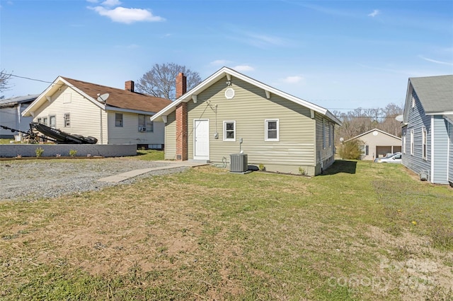 back of property with a lawn