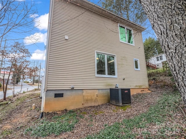 view of home's exterior featuring cooling unit and crawl space