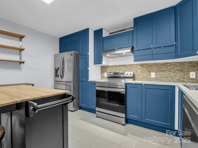 kitchen featuring stainless steel appliances, blue cabinetry, decorative backsplash, and under cabinet range hood