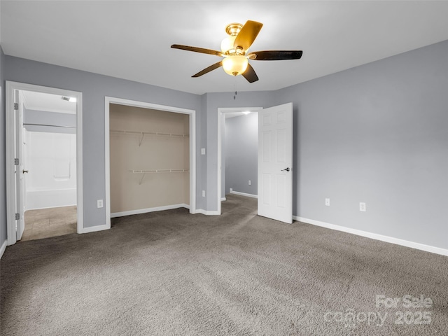 unfurnished bedroom with carpet floors, ceiling fan, baseboards, and a closet