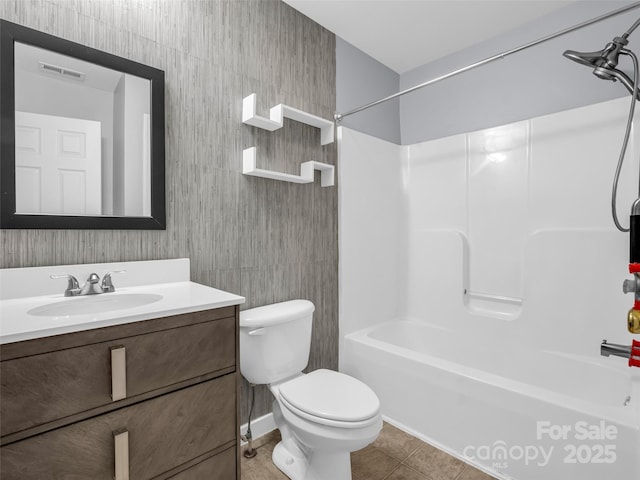 bathroom with shower / bath combination, visible vents, toilet, vanity, and tile patterned flooring