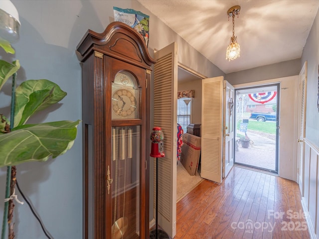 entrance foyer featuring vaulted ceiling and hardwood / wood-style flooring