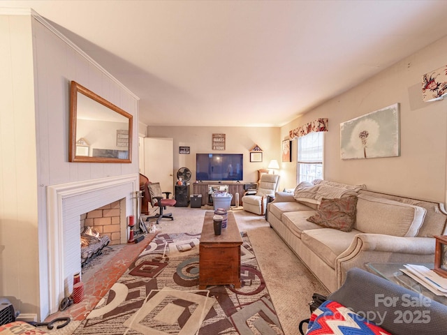 living area with carpet and a fireplace