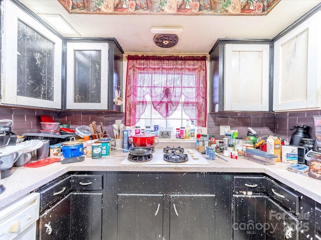 kitchen featuring white appliances, tasteful backsplash, and light countertops