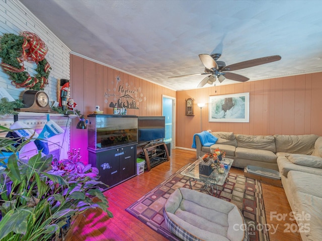 living area featuring ceiling fan and wood finished floors