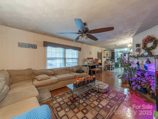 living room featuring hardwood / wood-style flooring and a ceiling fan