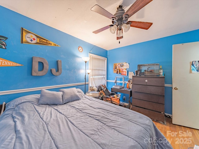 bedroom featuring ceiling fan and wood finished floors