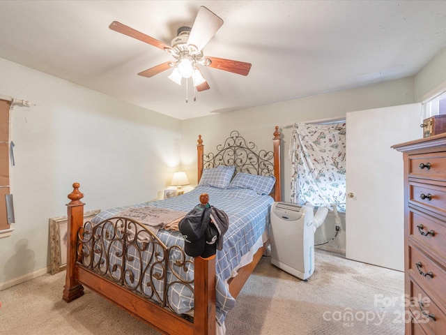 bedroom featuring baseboards, a ceiling fan, and light colored carpet