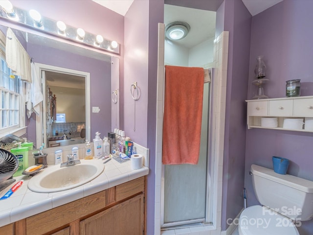 full bath with a shower stall, toilet, and vanity