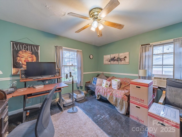 home office with a ceiling fan and baseboards