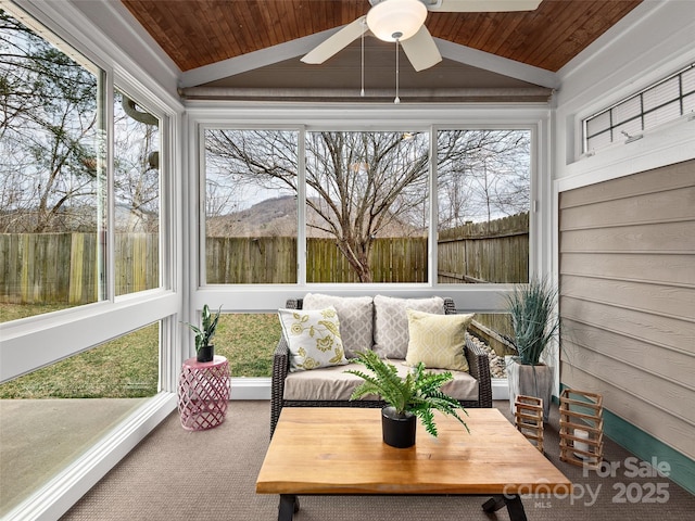 sunroom featuring lofted ceiling, wood ceiling, and a ceiling fan