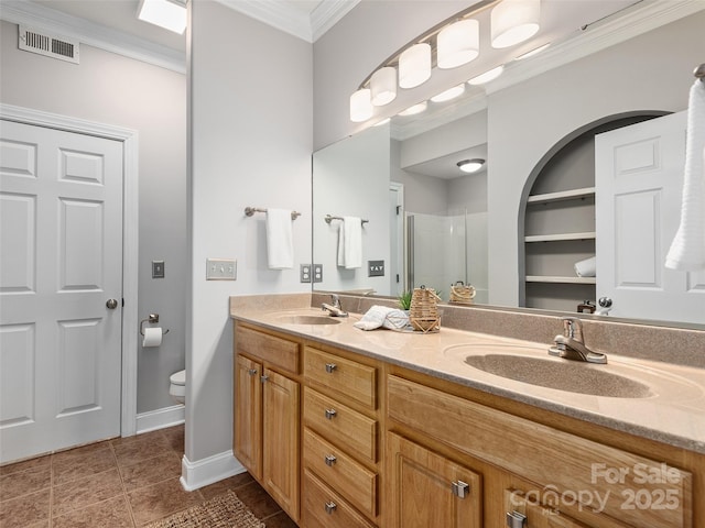 bathroom featuring a stall shower, a sink, visible vents, and crown molding