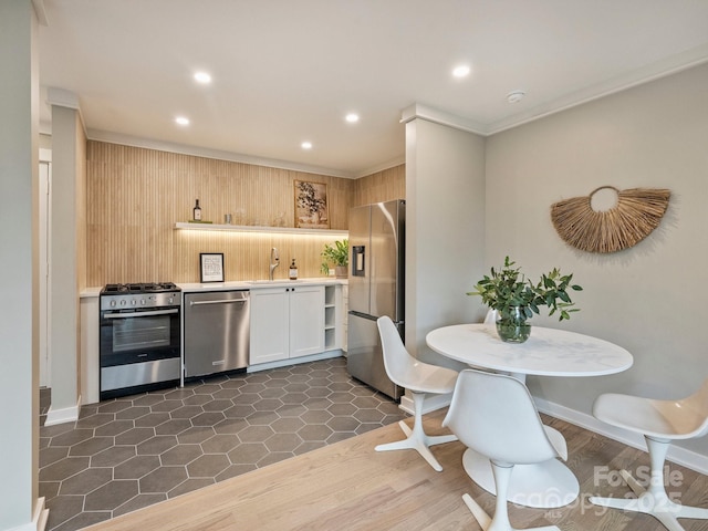 kitchen featuring a sink, light countertops, recessed lighting, stainless steel appliances, and dark tile patterned flooring