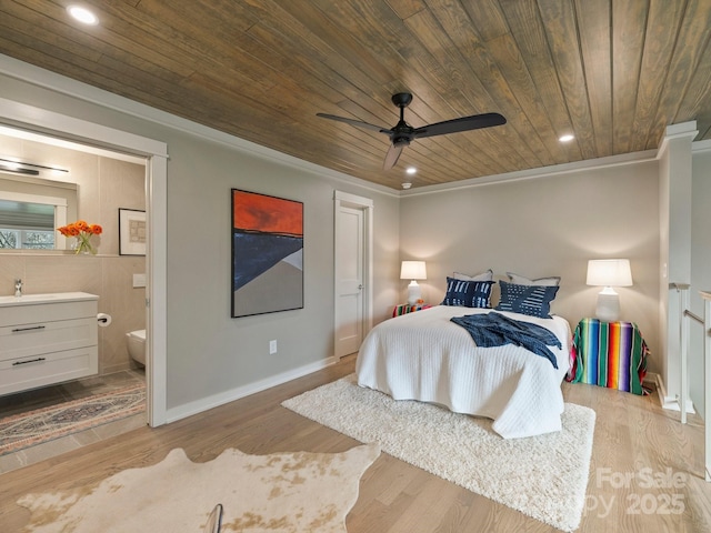 bedroom featuring wood finished floors, ensuite bath, recessed lighting, a sink, and wood ceiling