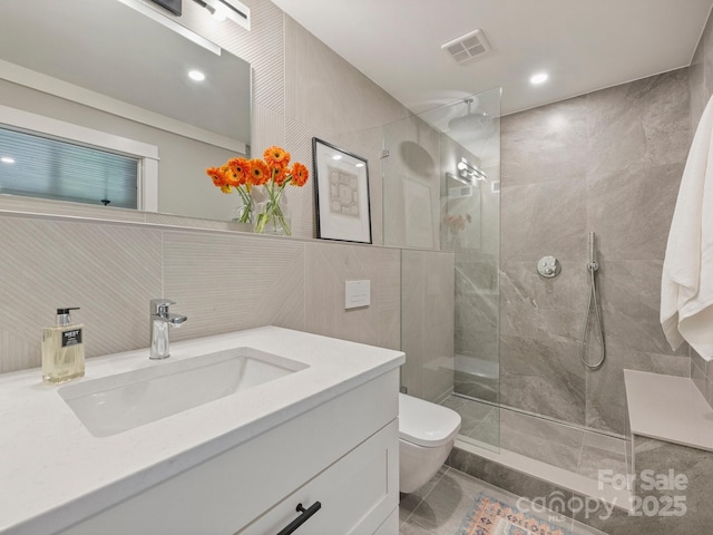 full bath featuring visible vents, toilet, tile walls, and walk in shower