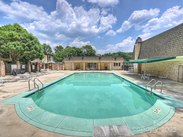 pool featuring a patio and fence