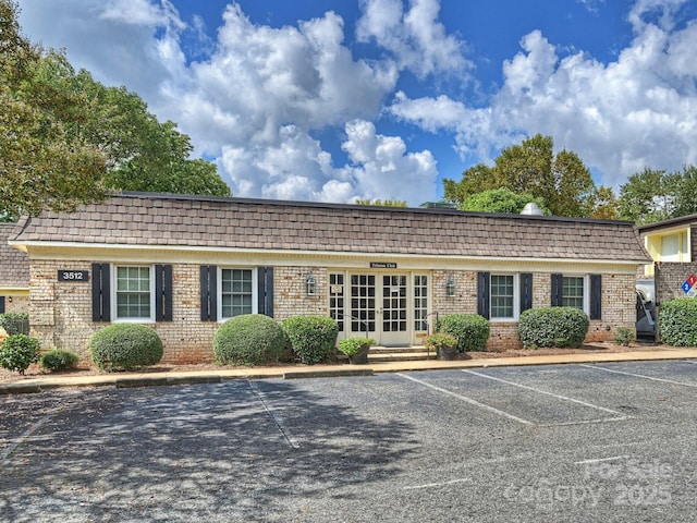 view of building exterior with uncovered parking