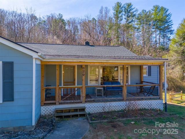 exterior space featuring a shingled roof and covered porch