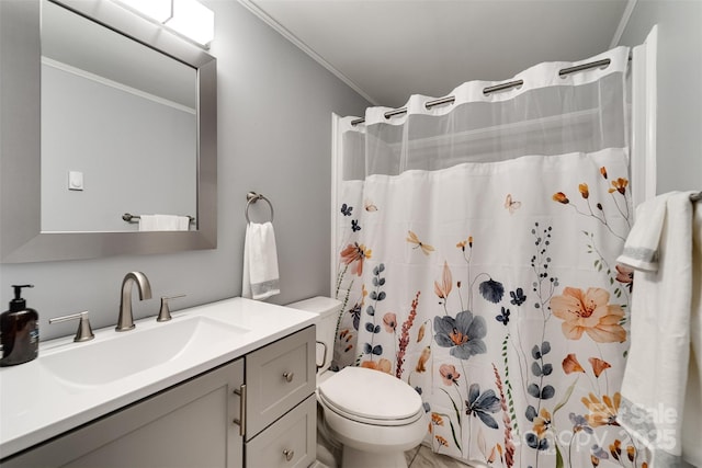 bathroom featuring curtained shower, crown molding, vanity, and toilet