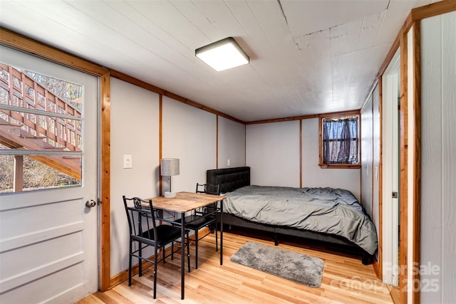 bedroom featuring multiple windows and wood finished floors