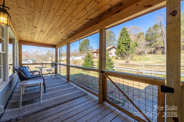 unfurnished sunroom featuring wooden ceiling