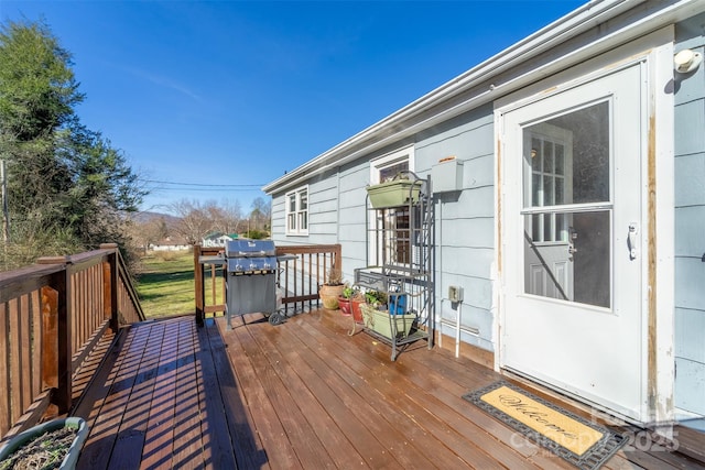 wooden terrace featuring grilling area