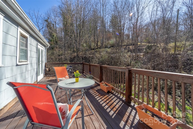 wooden terrace with outdoor dining space