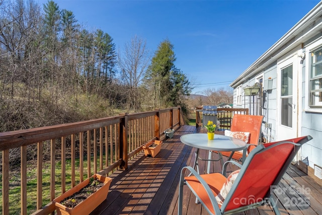 wooden terrace featuring outdoor dining space