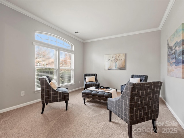 sitting room with carpet floors, ornamental molding, and baseboards