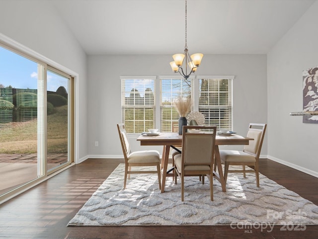 dining room with dark wood-type flooring, a healthy amount of sunlight, baseboards, and an inviting chandelier