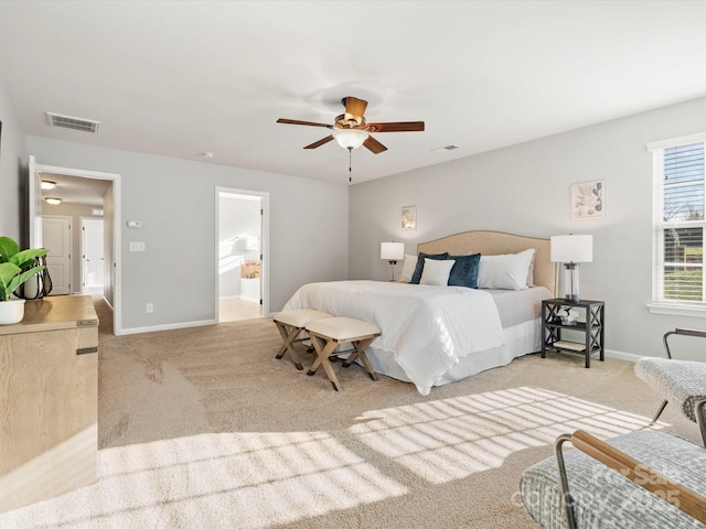 bedroom with baseboards, visible vents, and light colored carpet