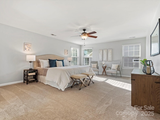 bedroom featuring light carpet, ceiling fan, visible vents, and baseboards