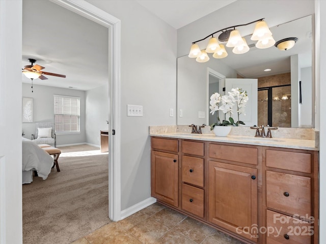 ensuite bathroom featuring tile patterned flooring, a sink, a shower stall, and double vanity